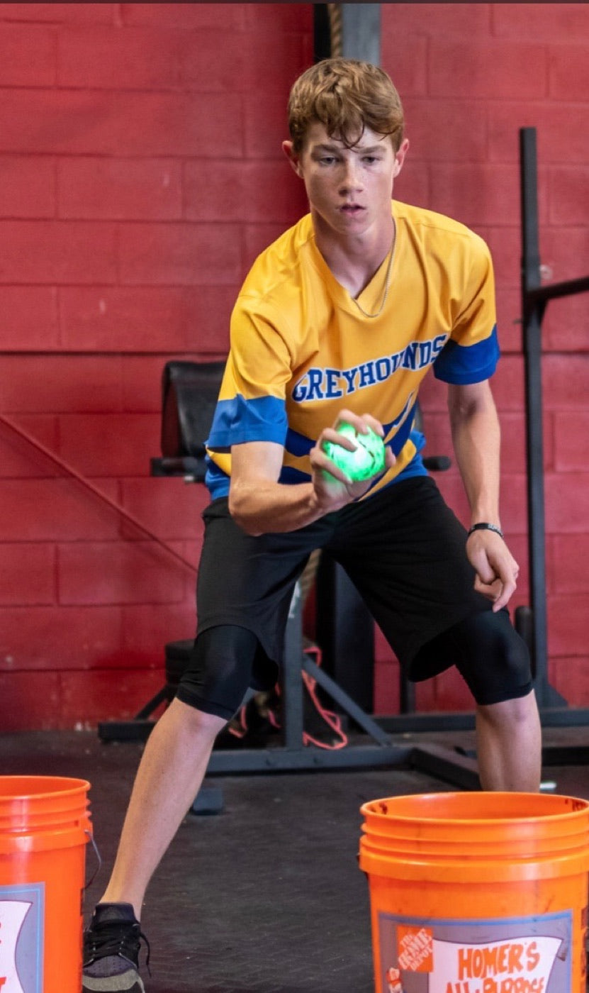 Athlete catching a glowing Vector Ball in the gym